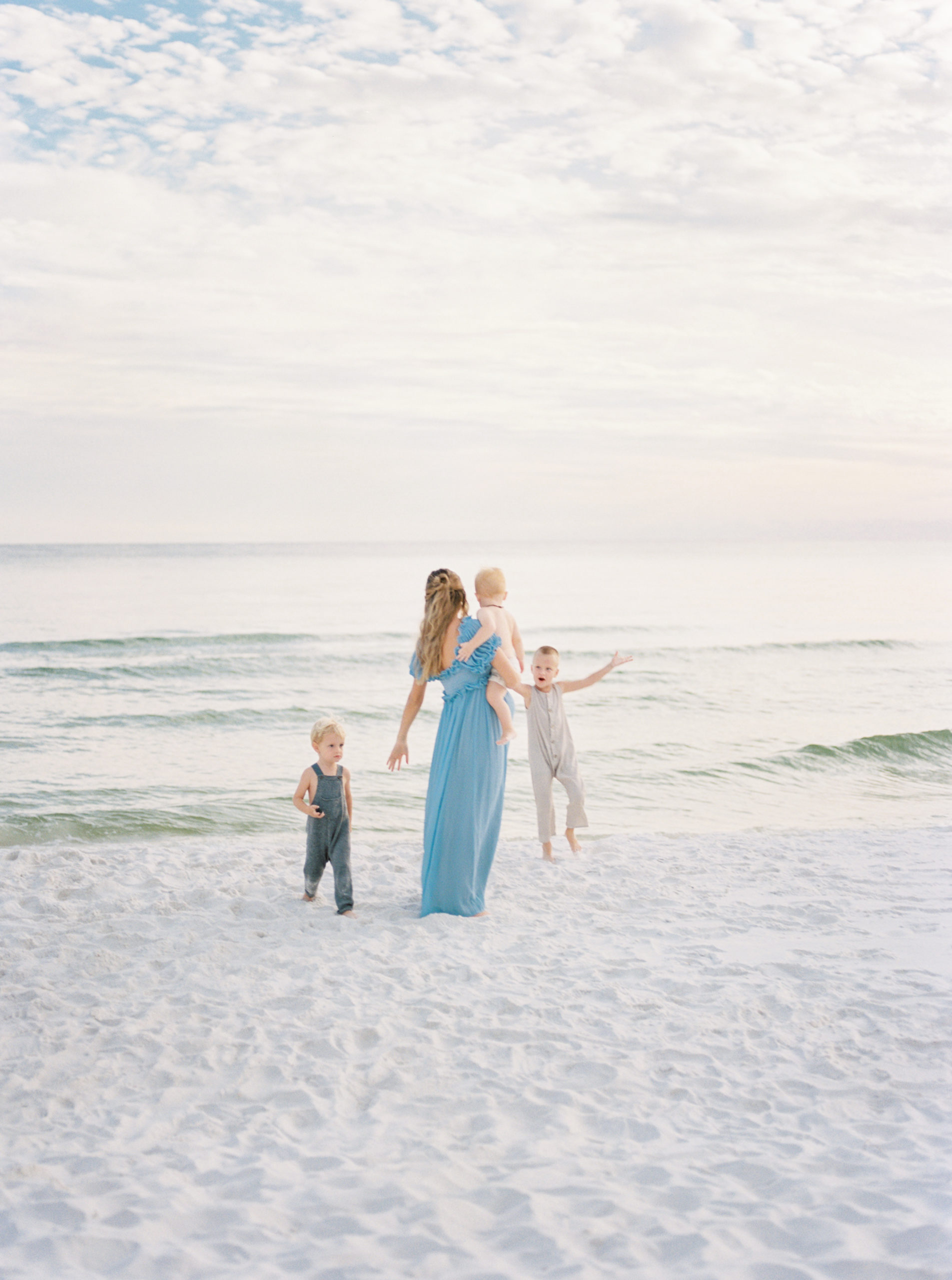 Beautiful beach maternity session with a mother and her 4 boys.