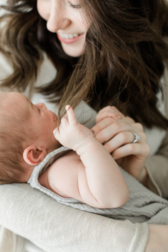baby tangled in mama's hair by Orlando newborn photographers