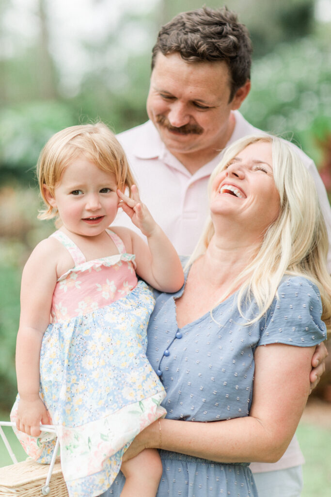 family laughing  together at the park by Orlando Lifestyle photographer 