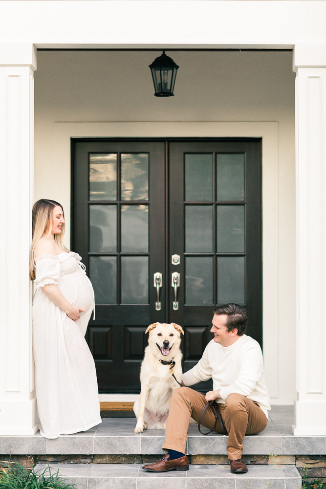 expecting parents on front porch with their dog by Orlando Maternity Photographer