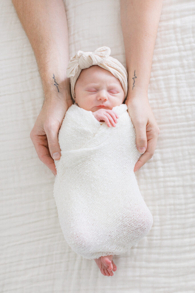 mom and dad with new baby by Orlando newborn photographer. 