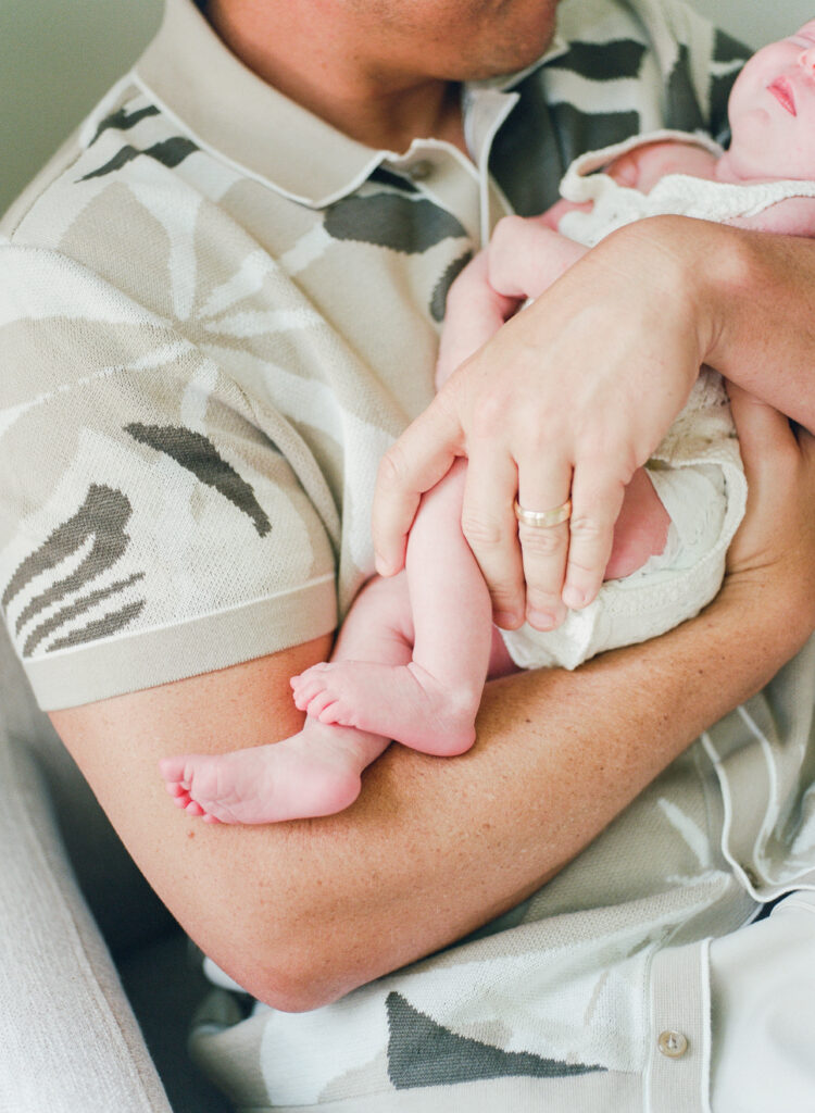 Dad at home with new baby girl.