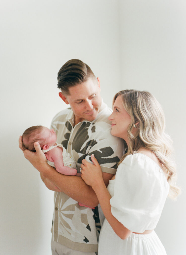 Delighted parents  at home with their new baby. 