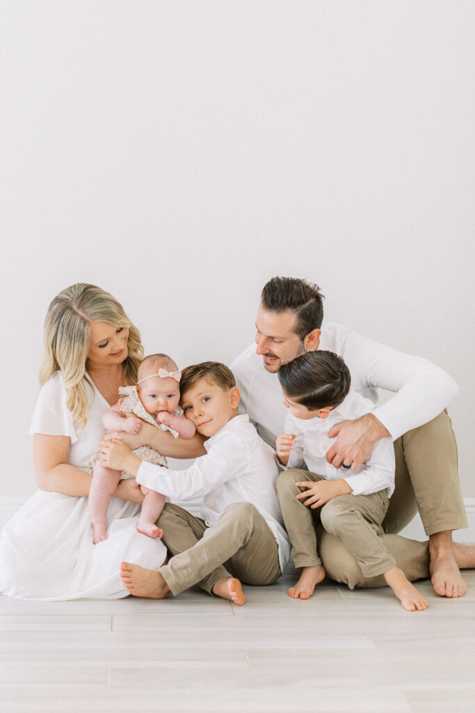 Family welcoming baby sister by Orlando newborn photographer.
