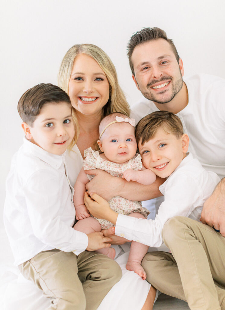Happy family at home with newest sibling.