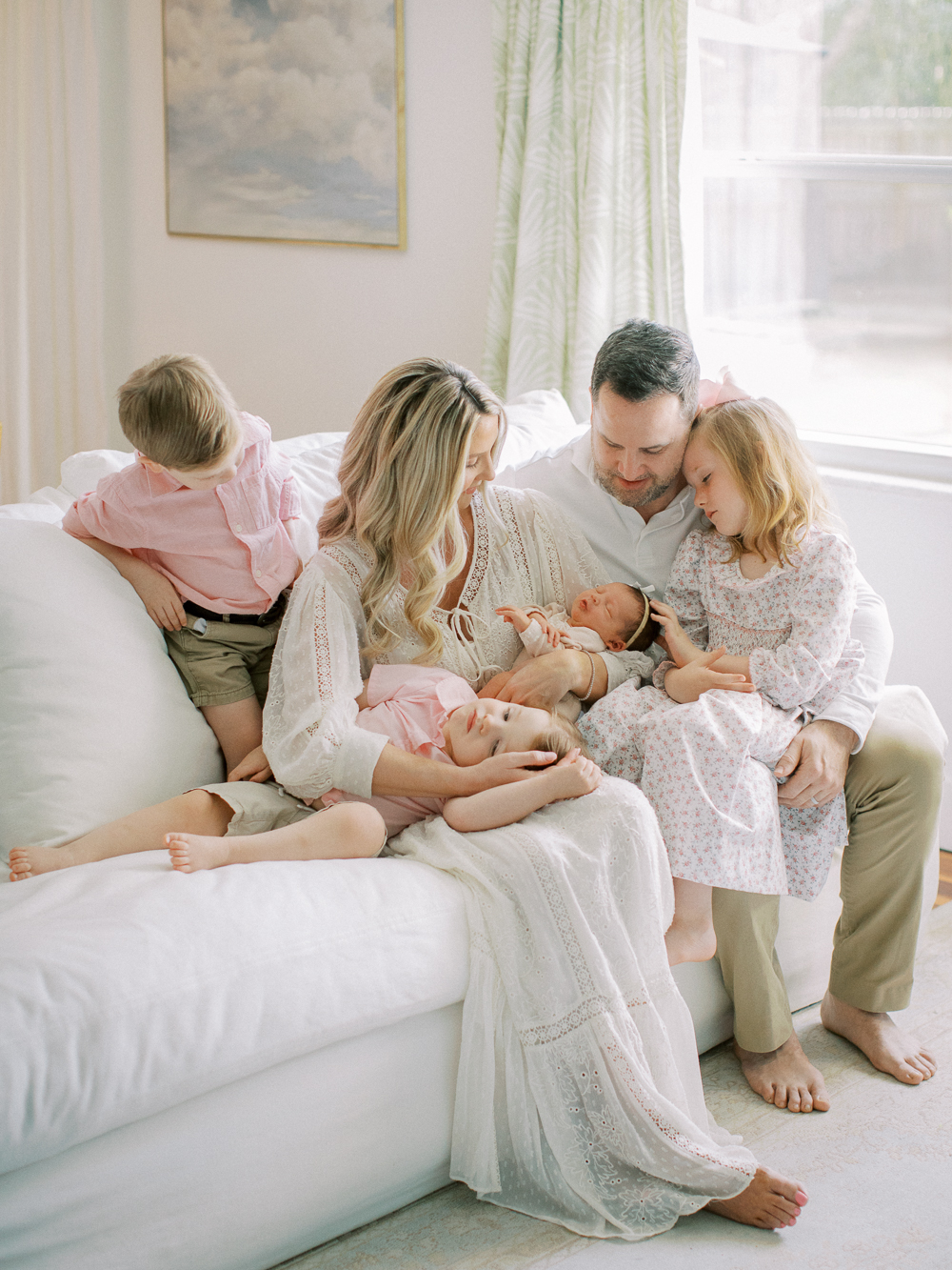 Joyful moment captured of family relaxing together at home with new baby during lifestyle newborn shoot