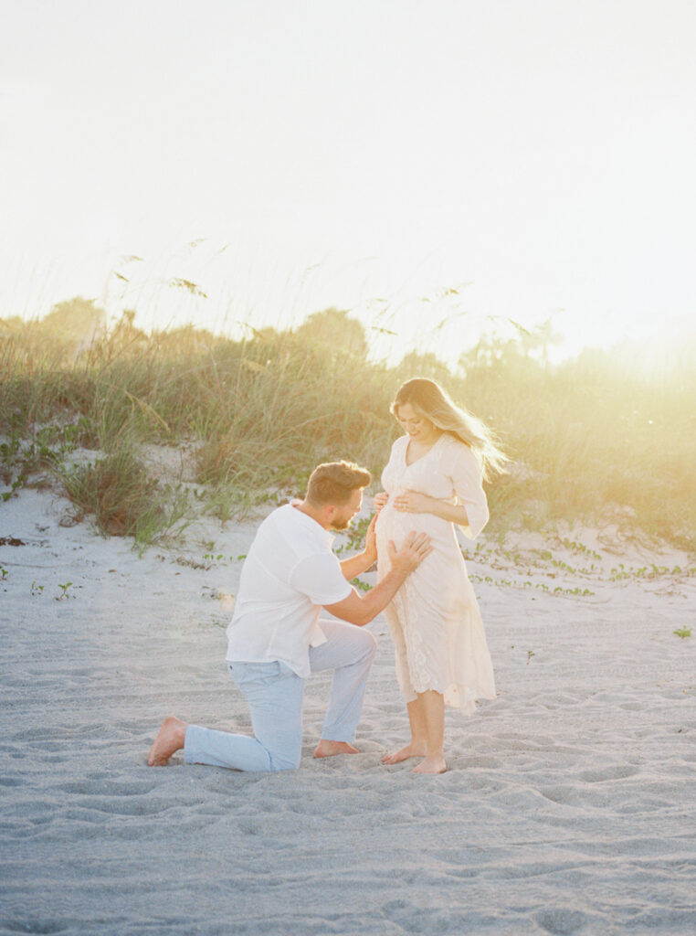 Candid maternity photo of parents-to-be during relaxed photography session in Orlando