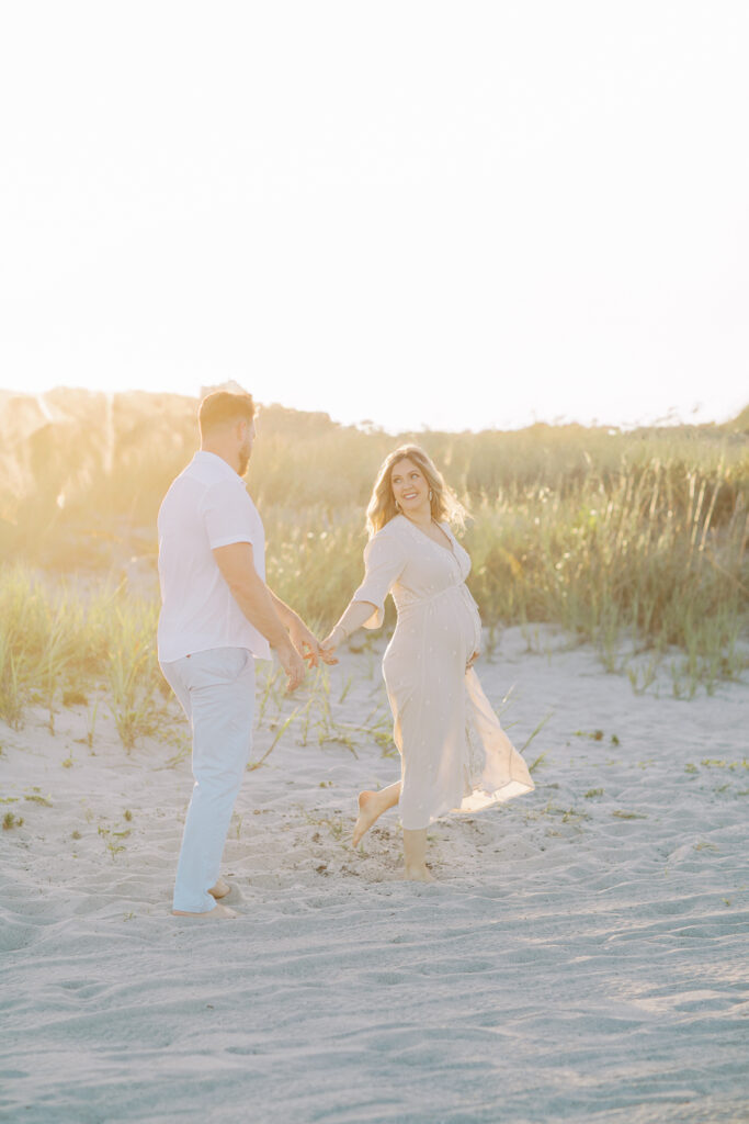 Candid maternity photo of mom-to-be laughing during relaxed photography session in Orlando