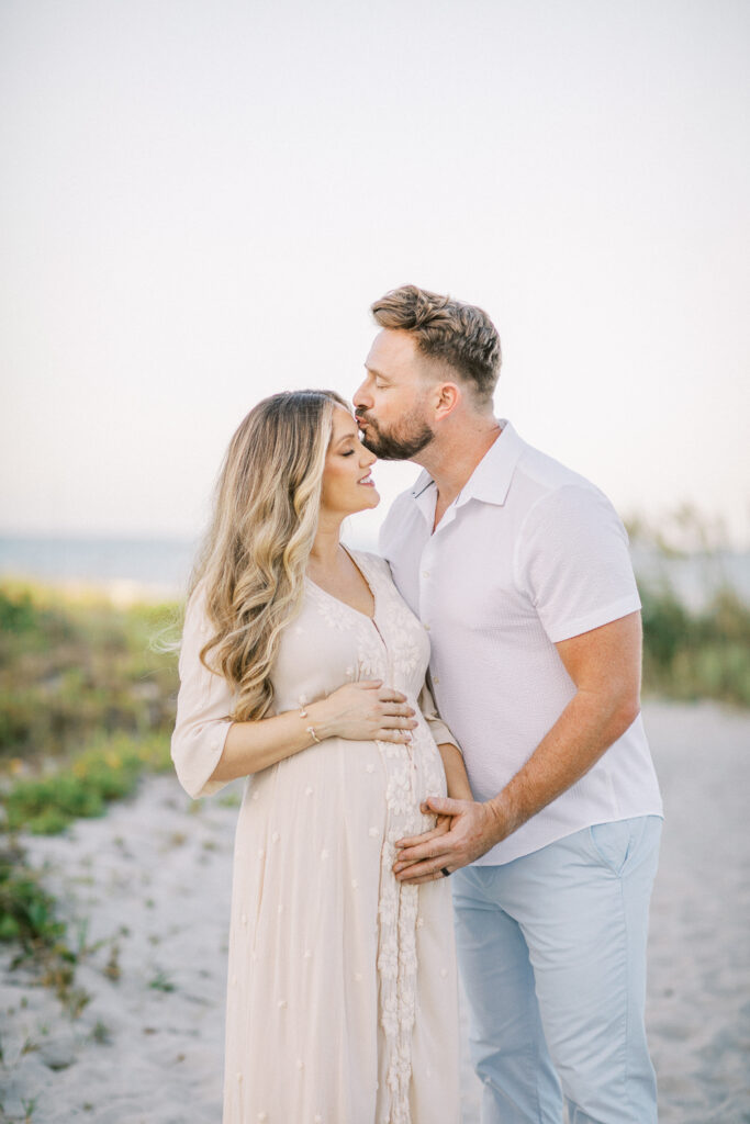 Expecting couple embracing during outdoor maternity session in Winter Park FL