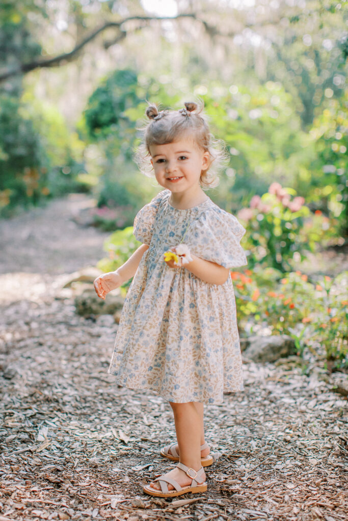 Two-year-old exploring with parents watching nearby by Orlando family photographer.