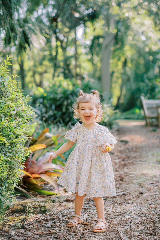 Toddler laughing in early morning natural light in Orlando, FL.