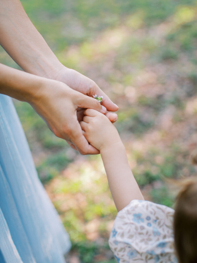 Detail shot of mom and daughter's hands at family session in Orlando, FL.