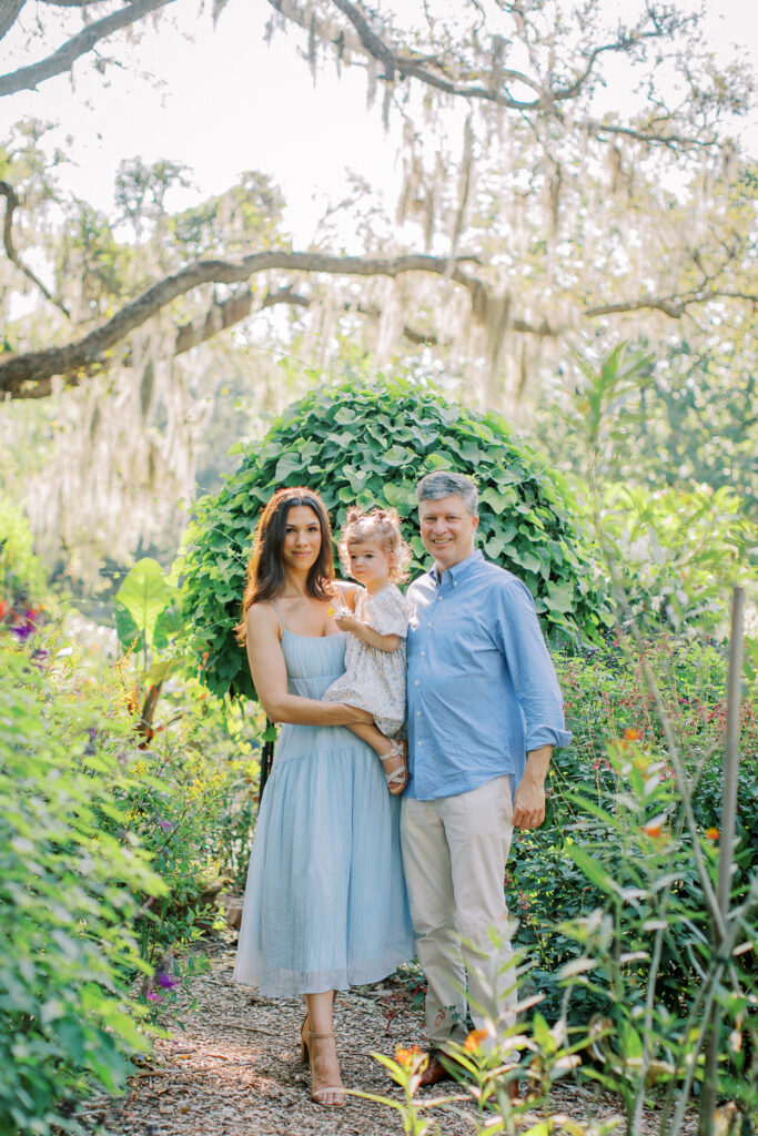Quiet moment of family with golden light streaming through trees in Orlando, FL.