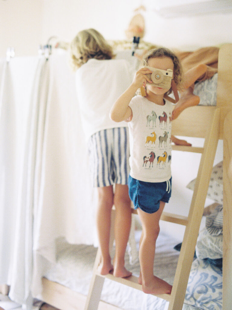Mom photographing her children at home after completing the Motherhood Inspired photography course.