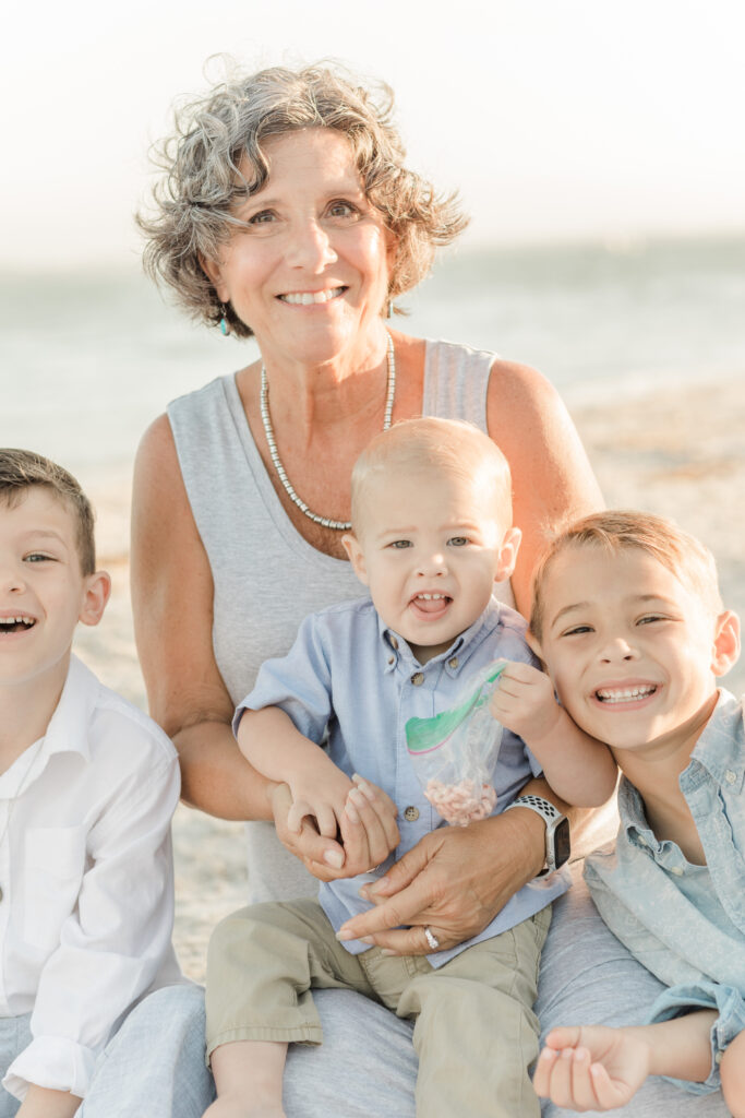 Grandparents hugging their grandchildren during an Orlando beach family photography session.