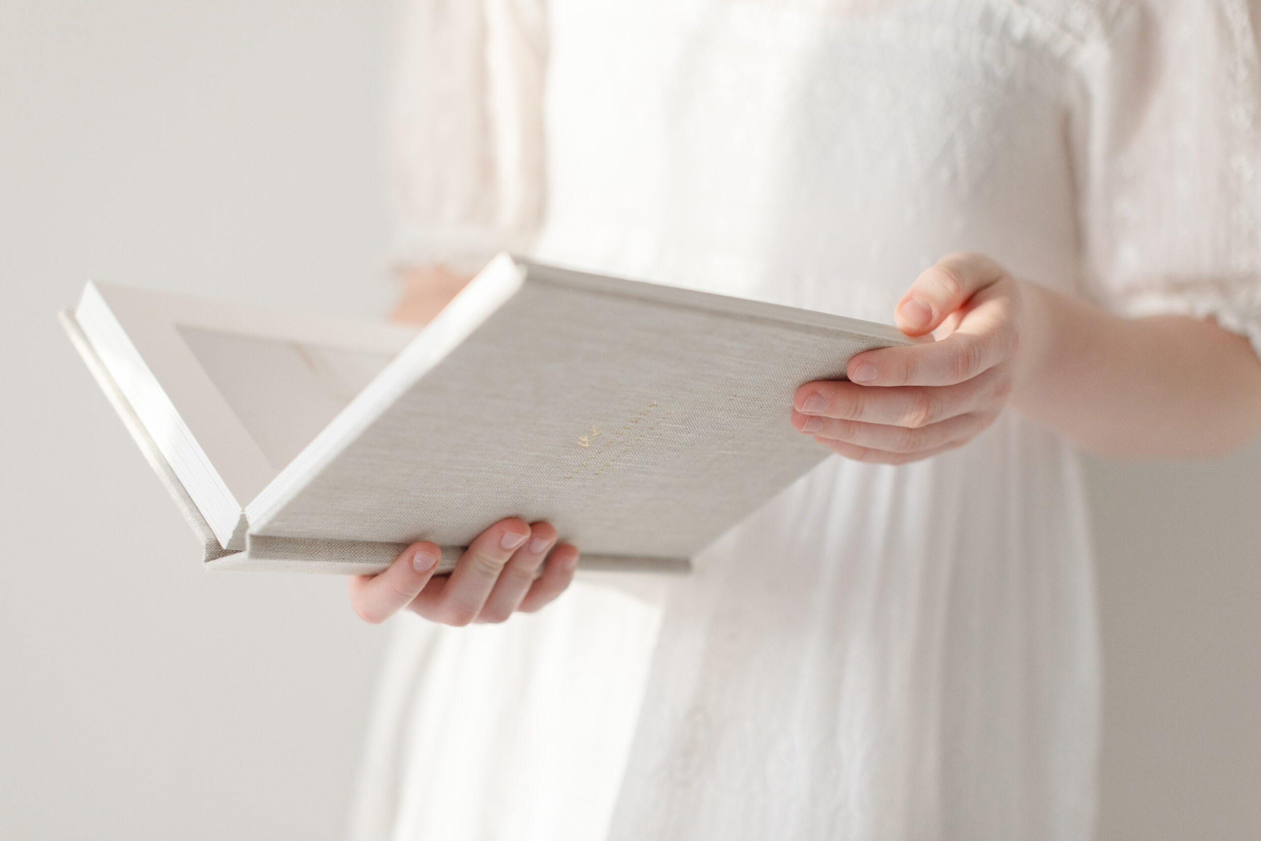 Luxury lay-flat heirloom album featuring lifestyle family portraits — a meaningful holiday gift for Mom.