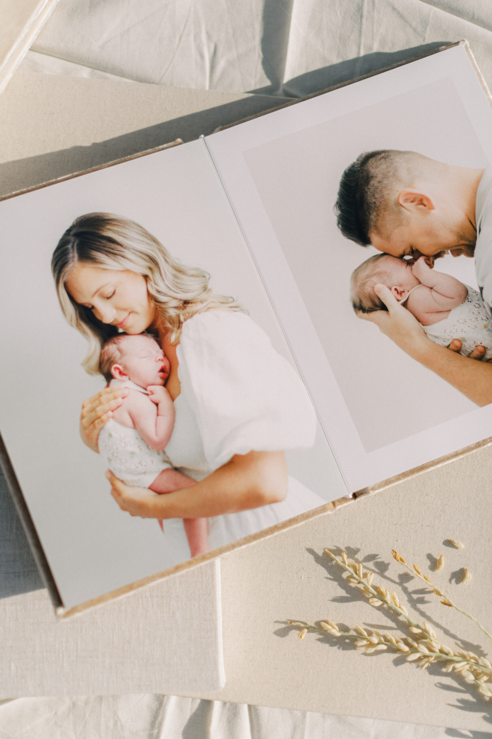 Open Heirloom Album with lay-flat pages displaying family portraits, photographed in Orlando.