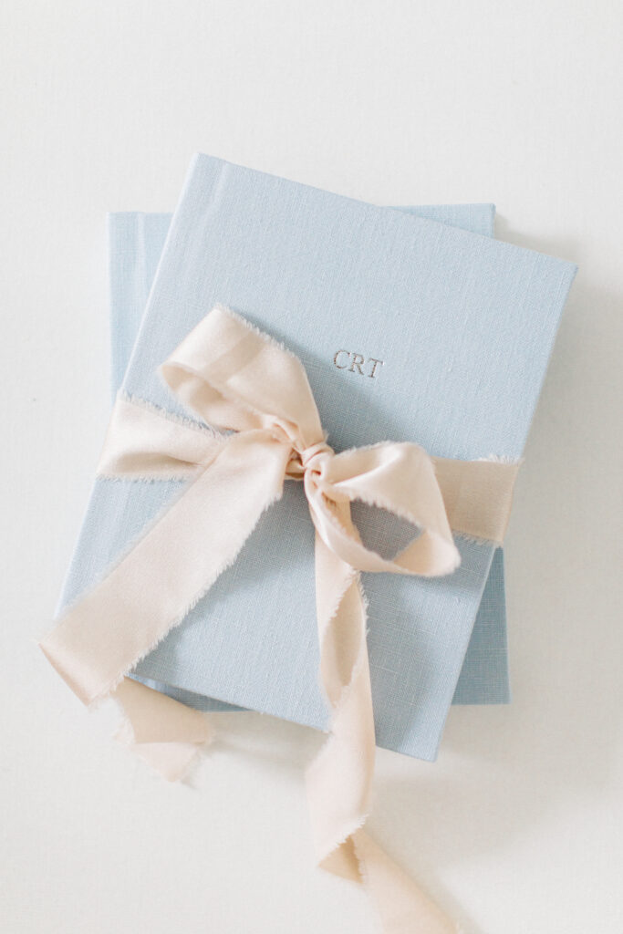 The Heirloom Album styled as a holiday gift with ribbon and evergreen accents, featured in The Scout Guide’s 2025 Gift Guide for Her.