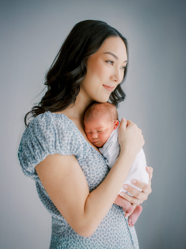 Mother holding baby during an Orlando in-home newborn session.