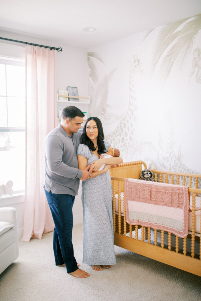 Orlando in-home newborn session in a cozy nursery with mother rocking baby.