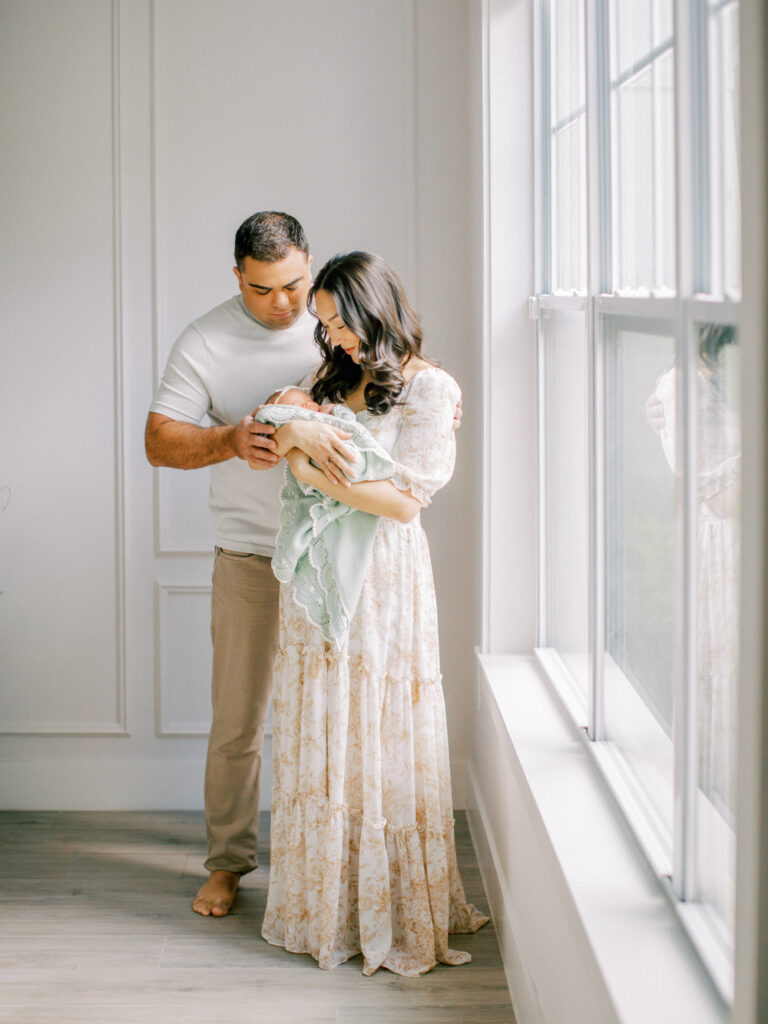Orlando photographer guiding relaxed newborn photo session at home.