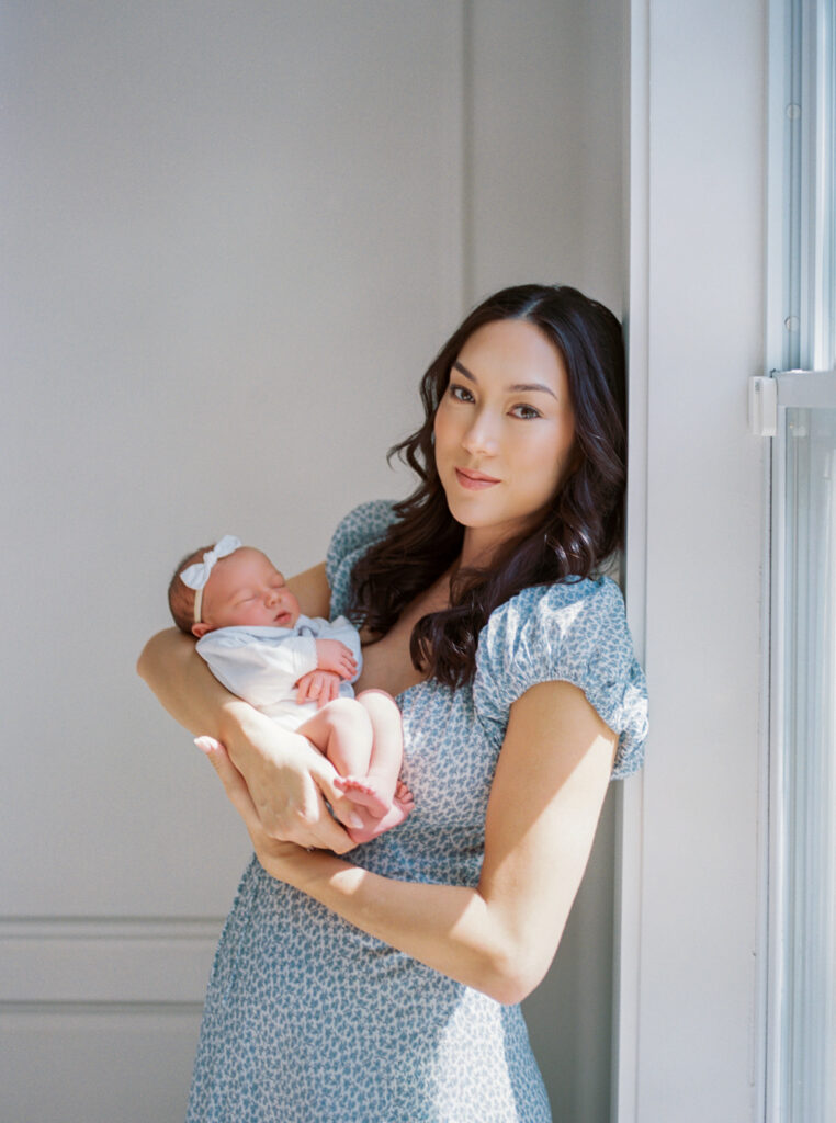 Orlando in-home newborn session with mother holding baby.