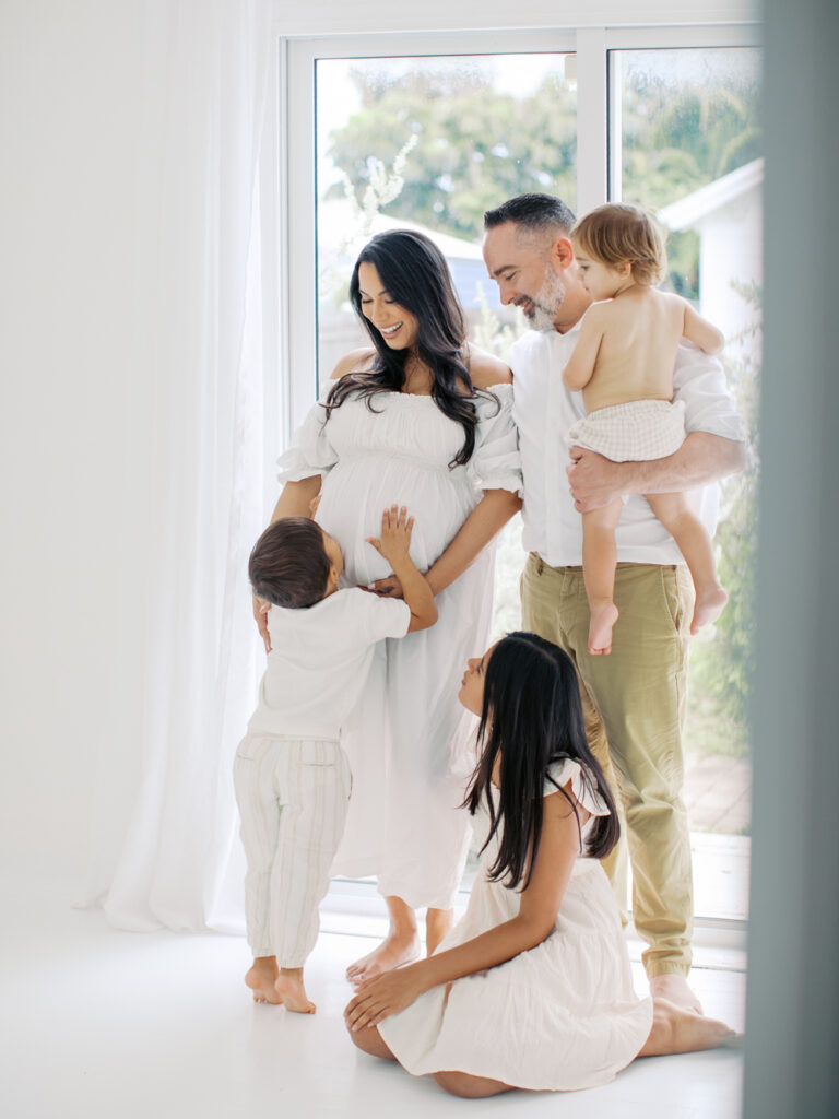 Family excitedly awaiting baby number 4 by Orlando maternity photographer. 