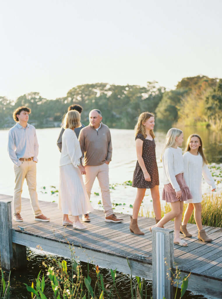Family walking together, engaged in a fun and spontaneous photography moment.