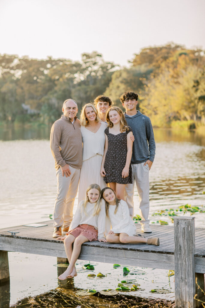 Family gathered on a dock, providing an idyllic and intimate backdrop for photos.