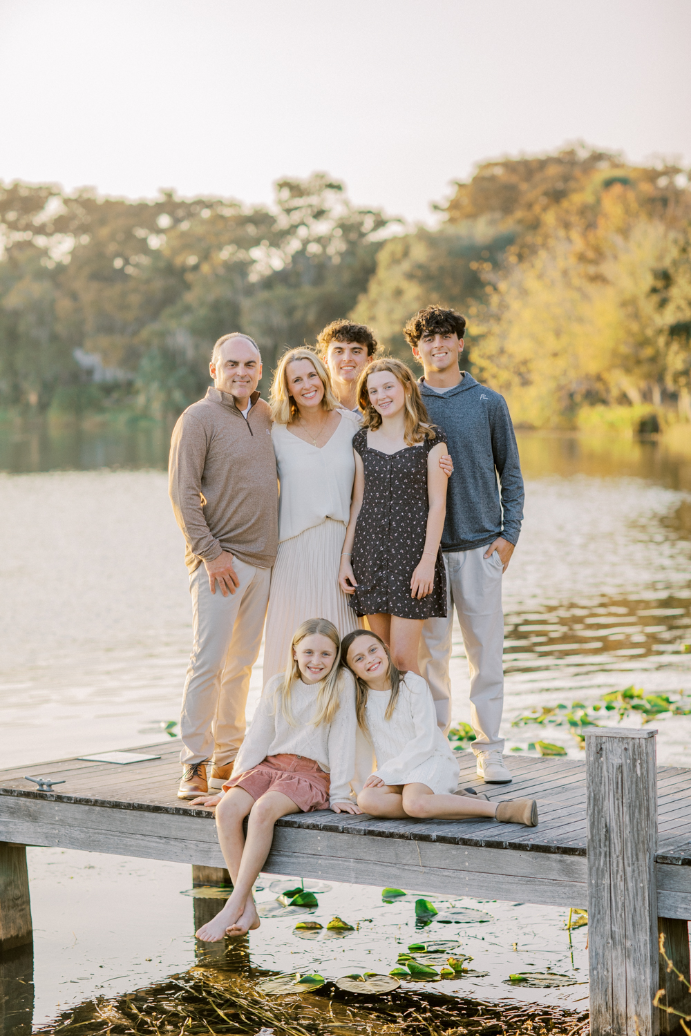 Family gathered on a dock, providing an idyllic and intimate backdrop for photos.