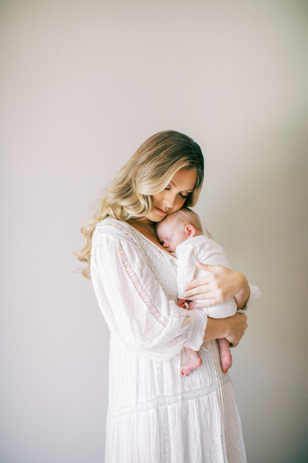 Busy mom photographed at home with her new baby in Orlando, FL.