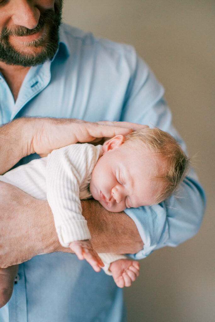 Dad with sleepy baby at a gorgeous in home session in Orlando, FL.