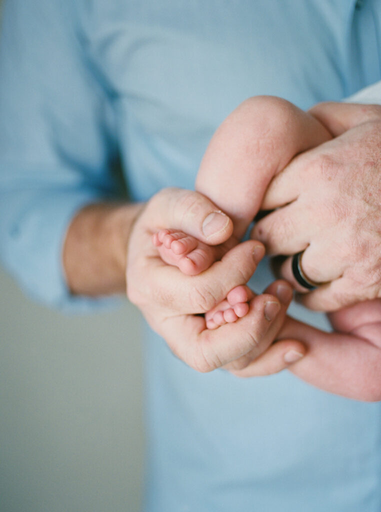 Baby details with dad at an in home session in Orlando, FL.