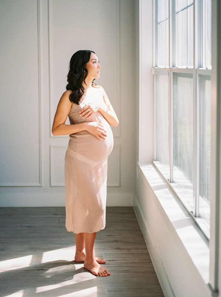 Expecting mother in gorgeous window light by Orlando maternity photographer.