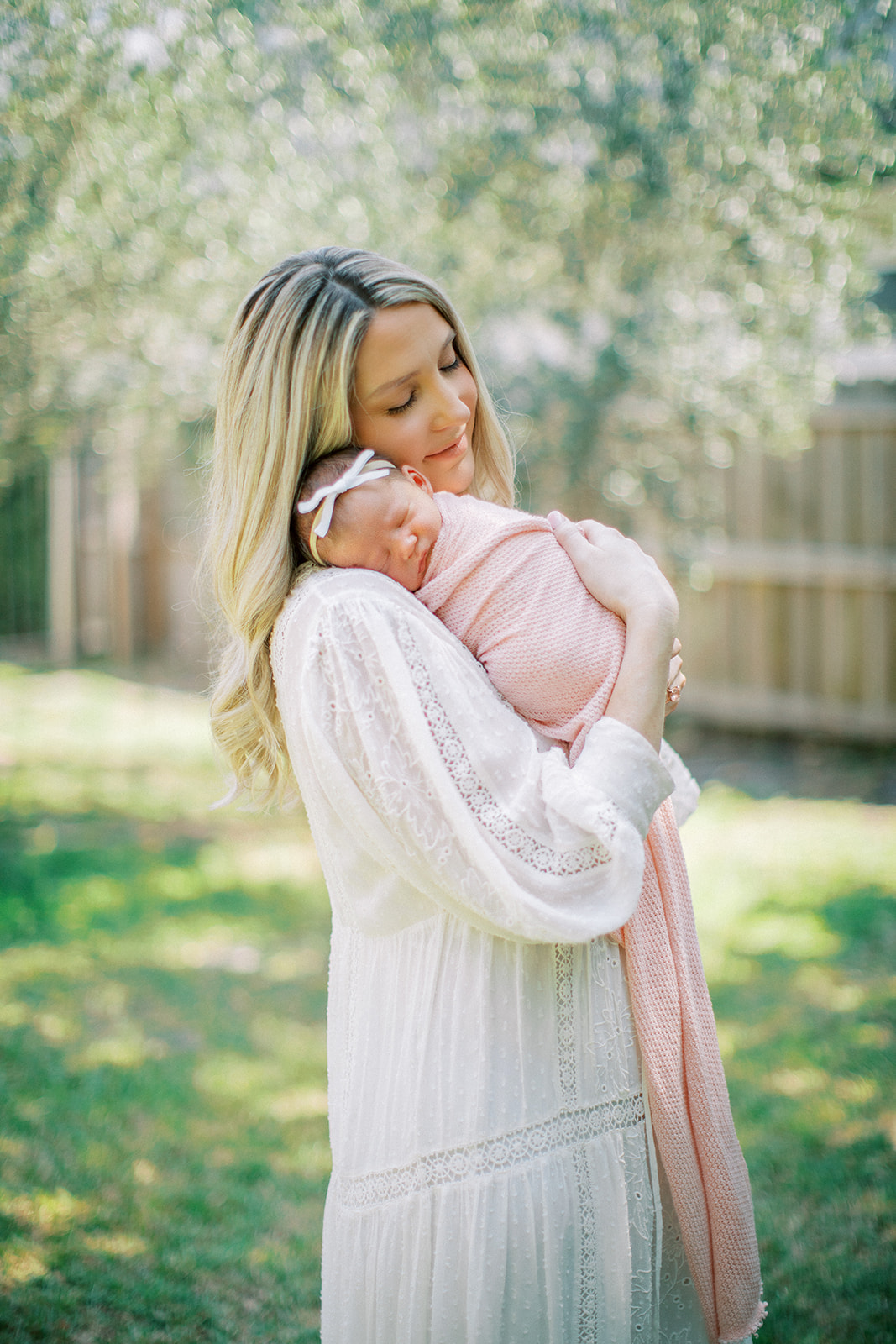 Mother snuggling her newborn baby at a lovely in-home session in Orlando, FL.
