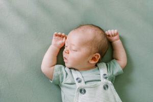 Baby baby boy sleeping in his crib in sublime light at an in home newborn session in Orlando, FL.