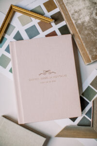 Custom gallery wall and album design with family photos from newborn and milestone sessions, Winter Park FL photographer.